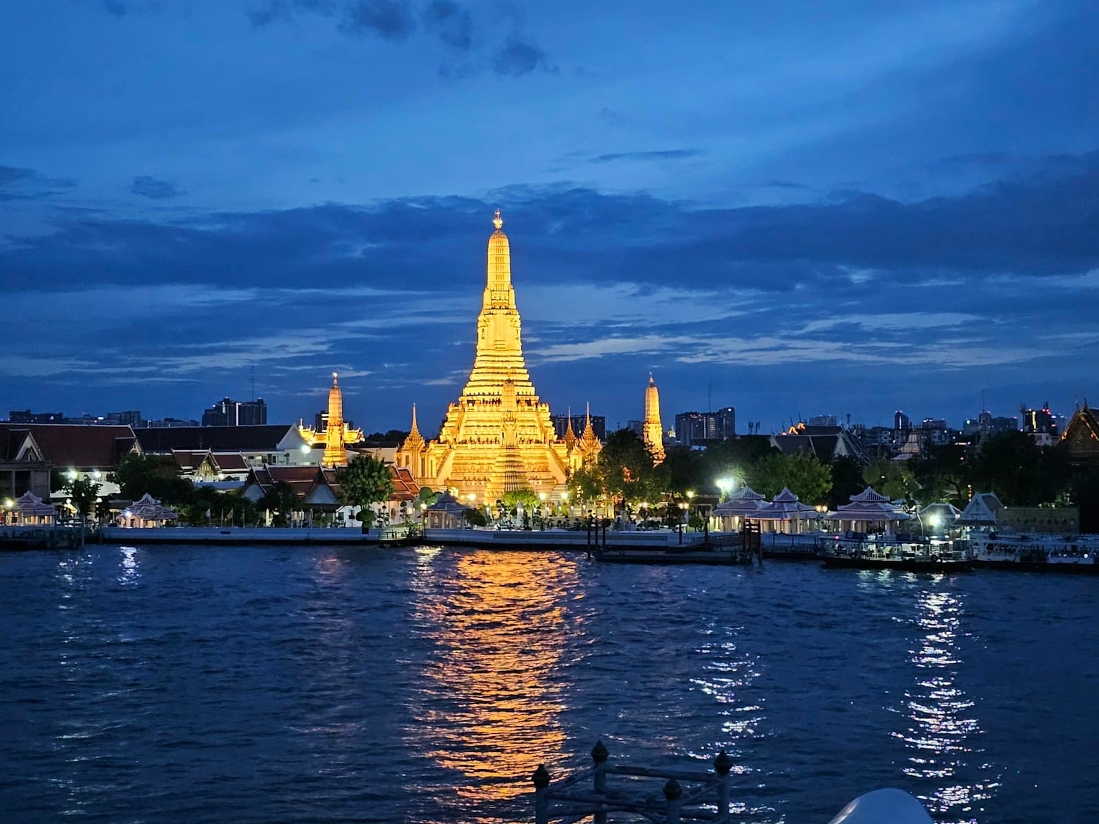Wat Arun lit at blue hour, reflected in the Chao Phraya, Bangkok